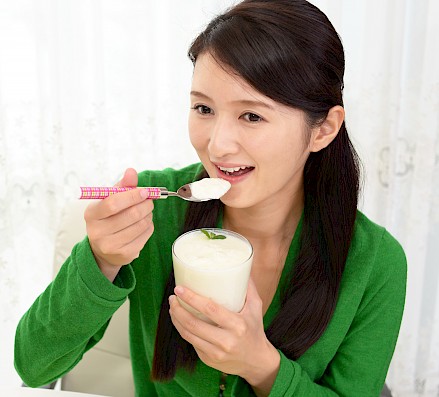 Woman eating soft food after tooth extraction.